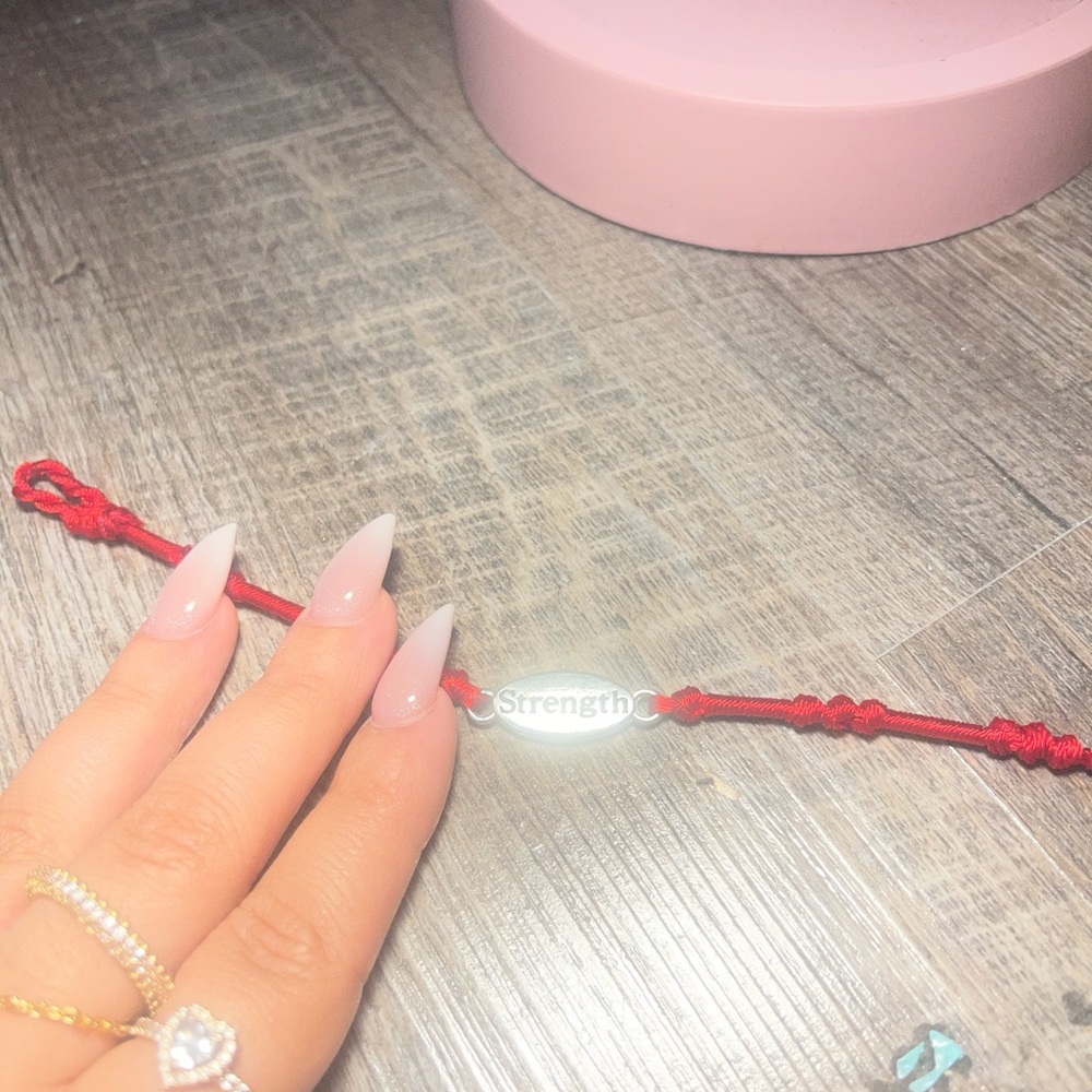 Red String Bracelet with 'Strength' Charm